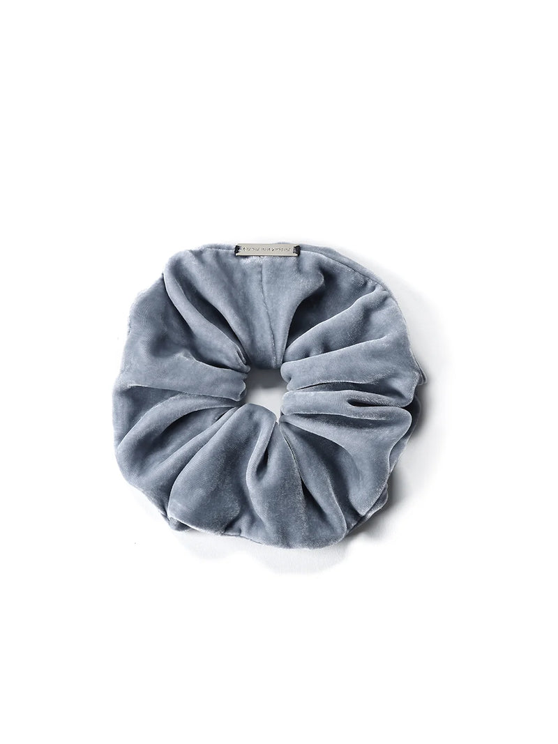 Blue Velvet scrunchie made of silk velvet with a hand-sewn logo